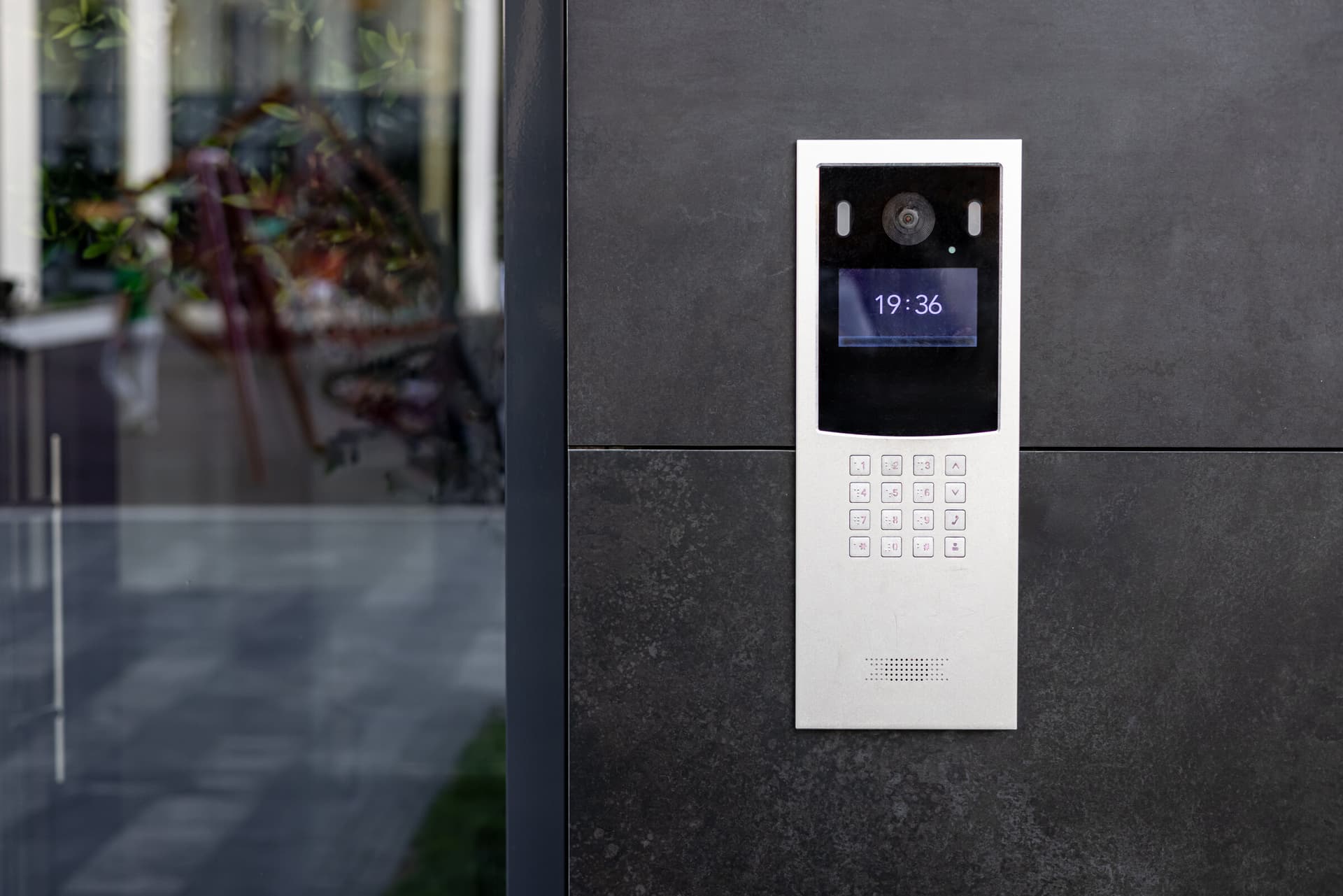 Modern intercom entry station mounted beside a building facade