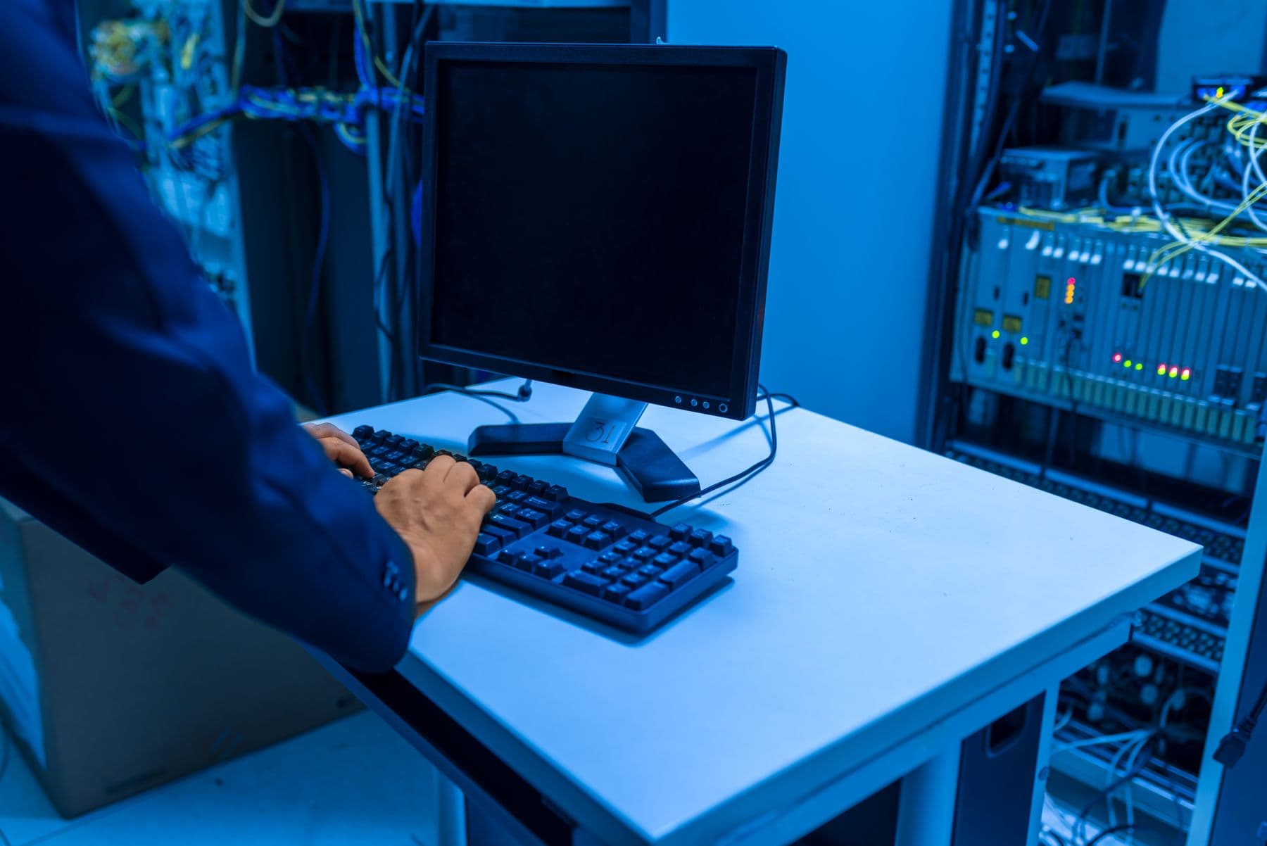 Technician working at a computer in a network operations room